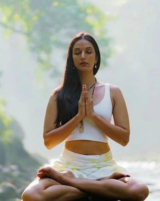 Ira Trivedi in meditation beside a waterfall